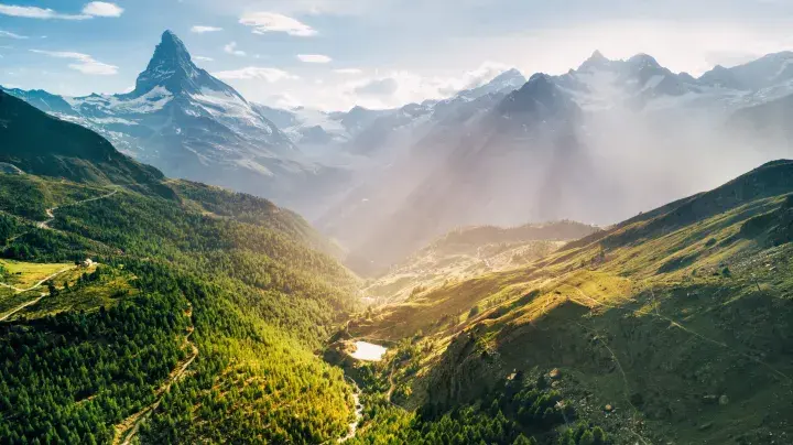 Sun through mountainous landscape 